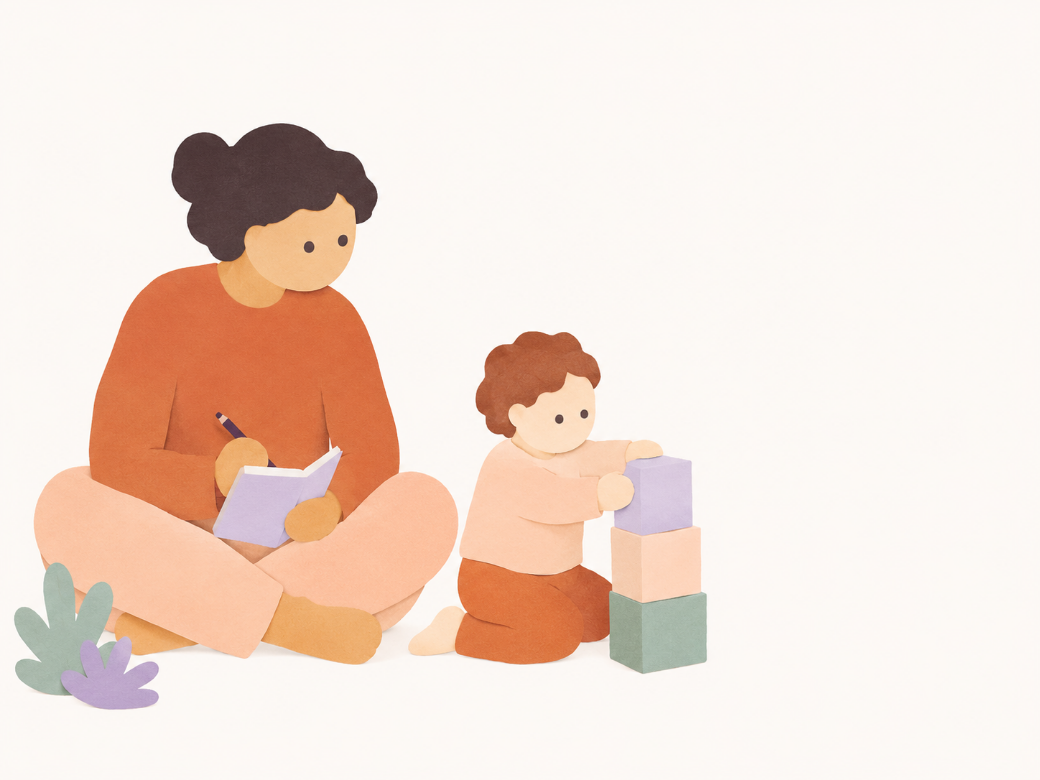 A caregiver sitting with a child and writing notes.
