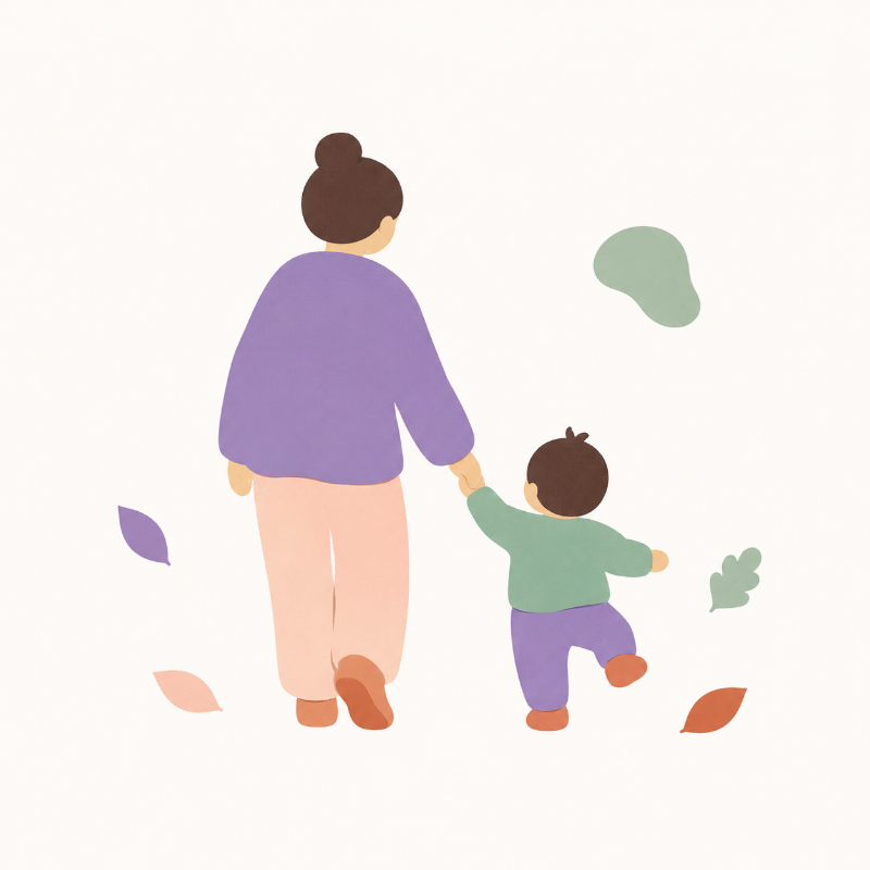 A caregiver walking outdoors with a young child.